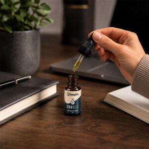 Hand met pipet van Hemplife CBG olie 5% 10ml met druppelende olie